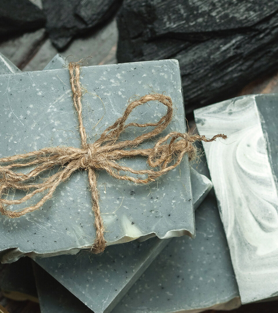 Looking down on various organic soaps tied with rope