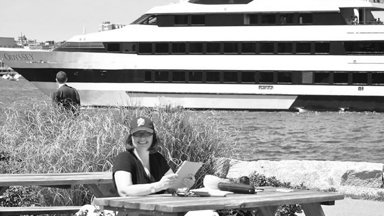 about adams design brenda adams sitting at table with yacht going by for brenda adams adams design boston graphic design studio