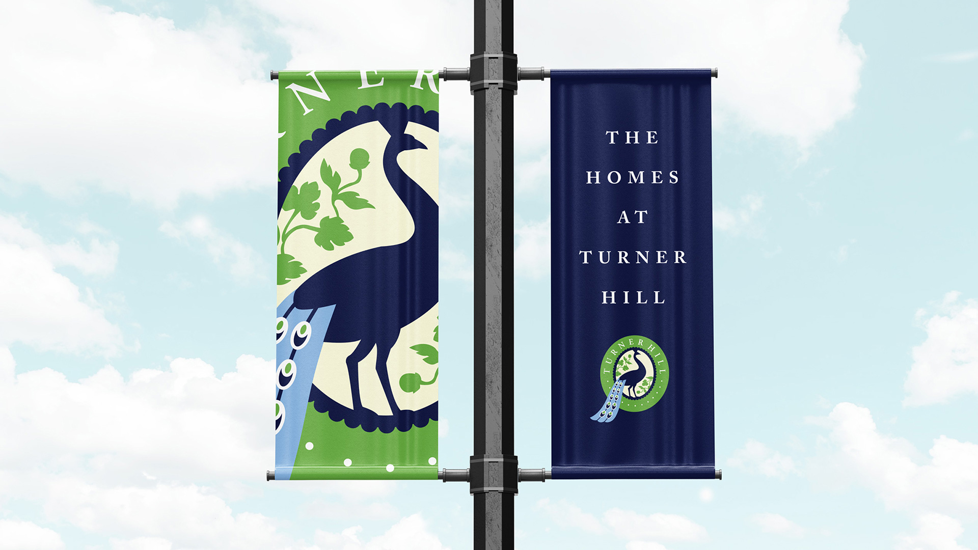 turner hill Pole flags against a blue sky with the turner hill logo on the left and The Homes of Turner HIll with the logo on the right