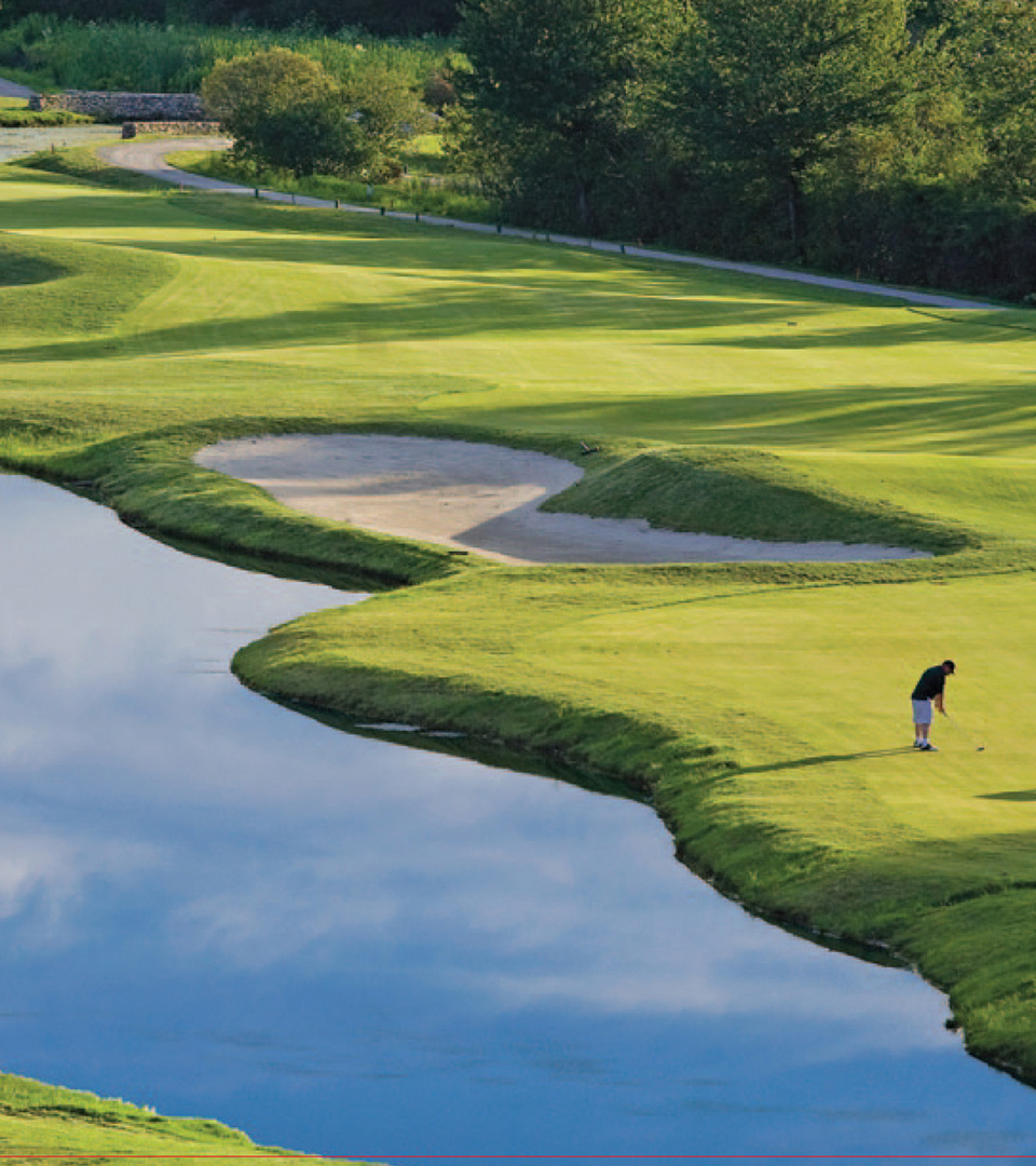 merrimack golf club golf course with water and golfer