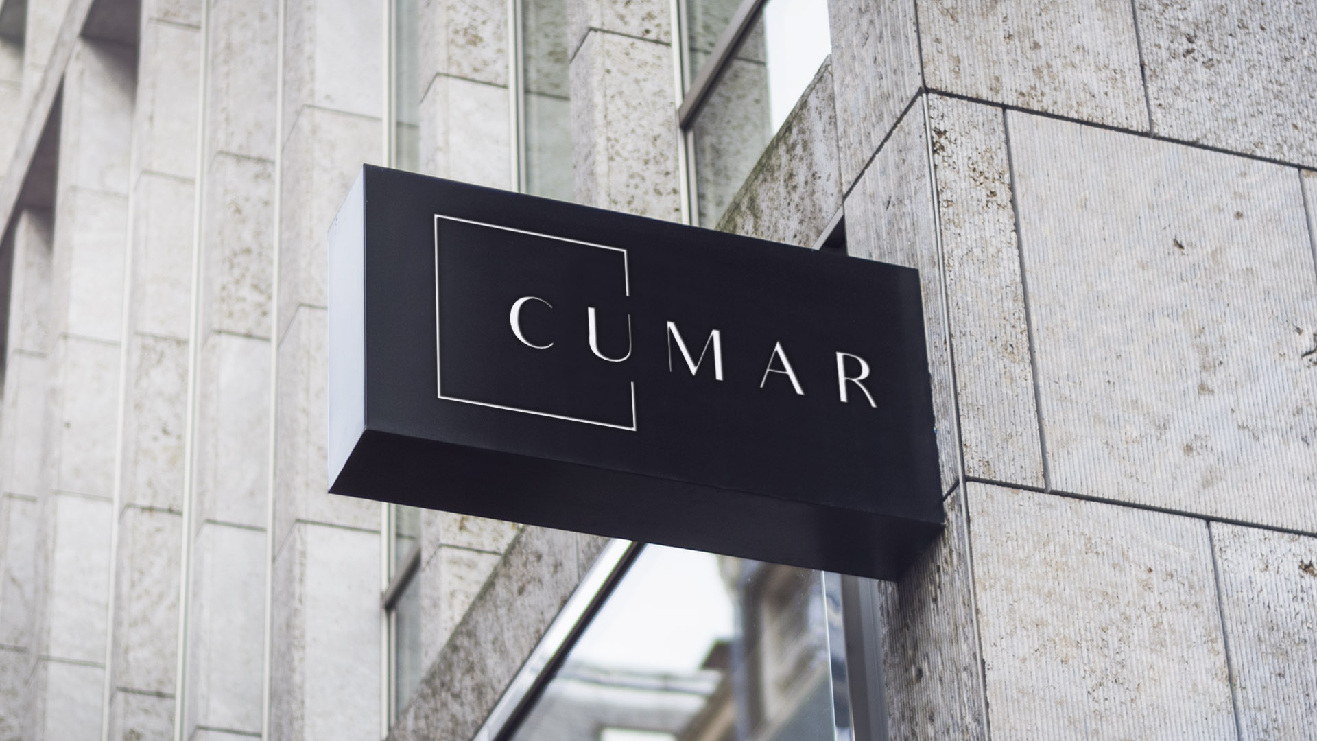 cumar building signage logo on black sign