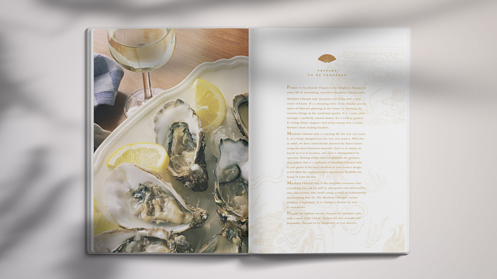 mandarin oriental residences brochure spread with wine and oysters