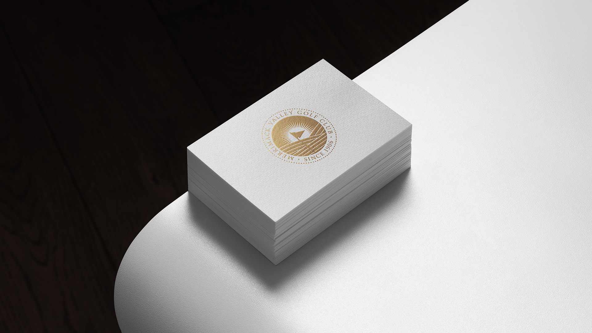 merrimack valley golf club business card in gold on white table