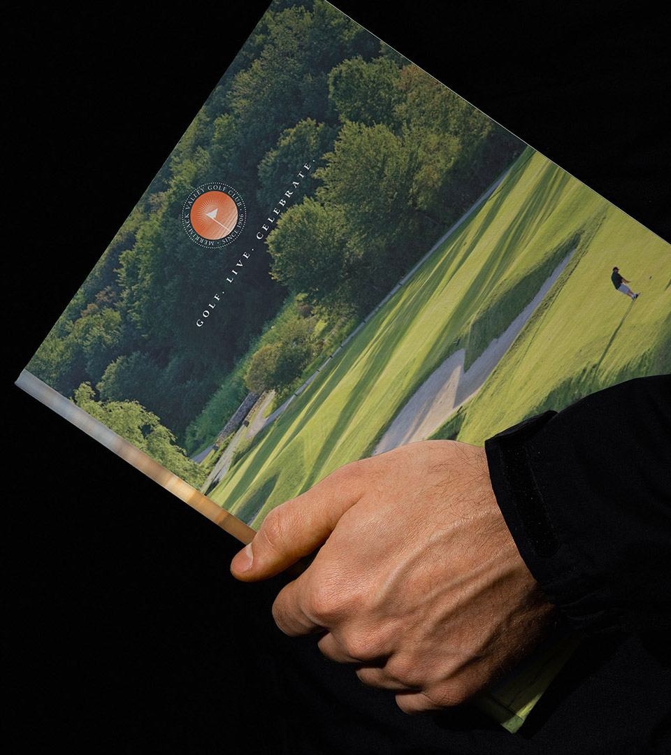 merrimack valley golf club man holding brochure vertical