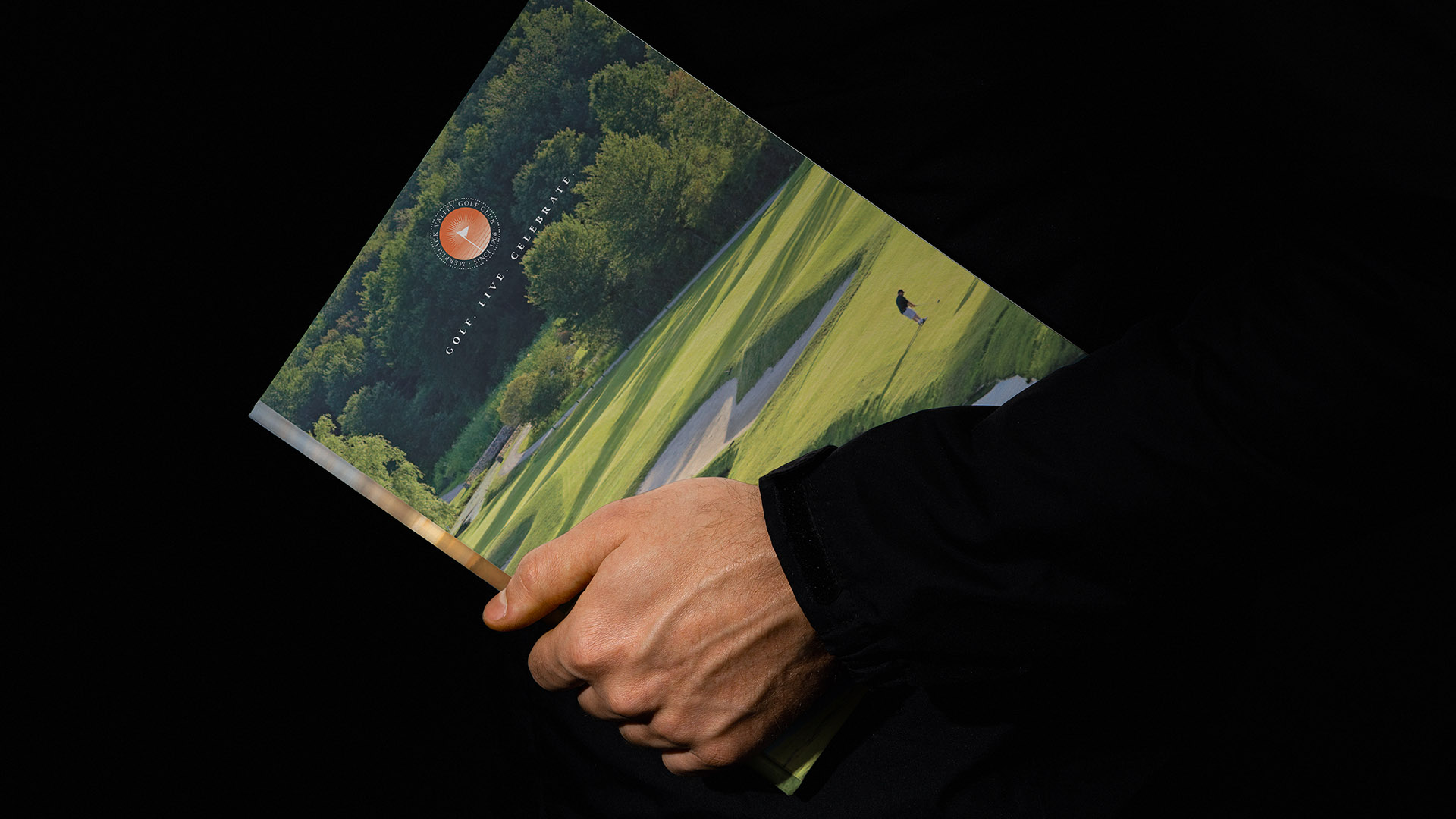 merrimack valley golf club man holding brochure