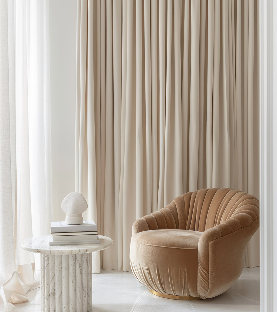 one dalton beige velvet chair in front of neutral drapes