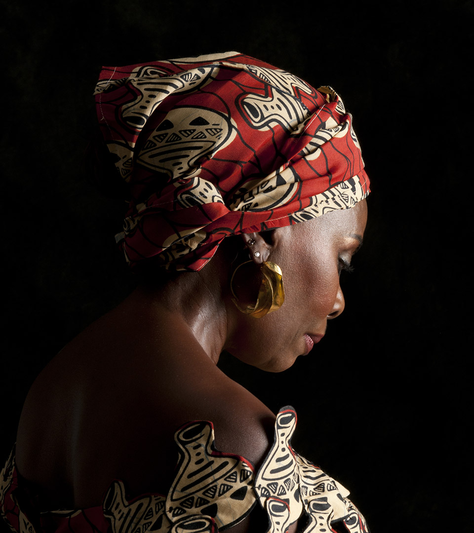 the gaila fund african american woman with red and beige scarf on her head